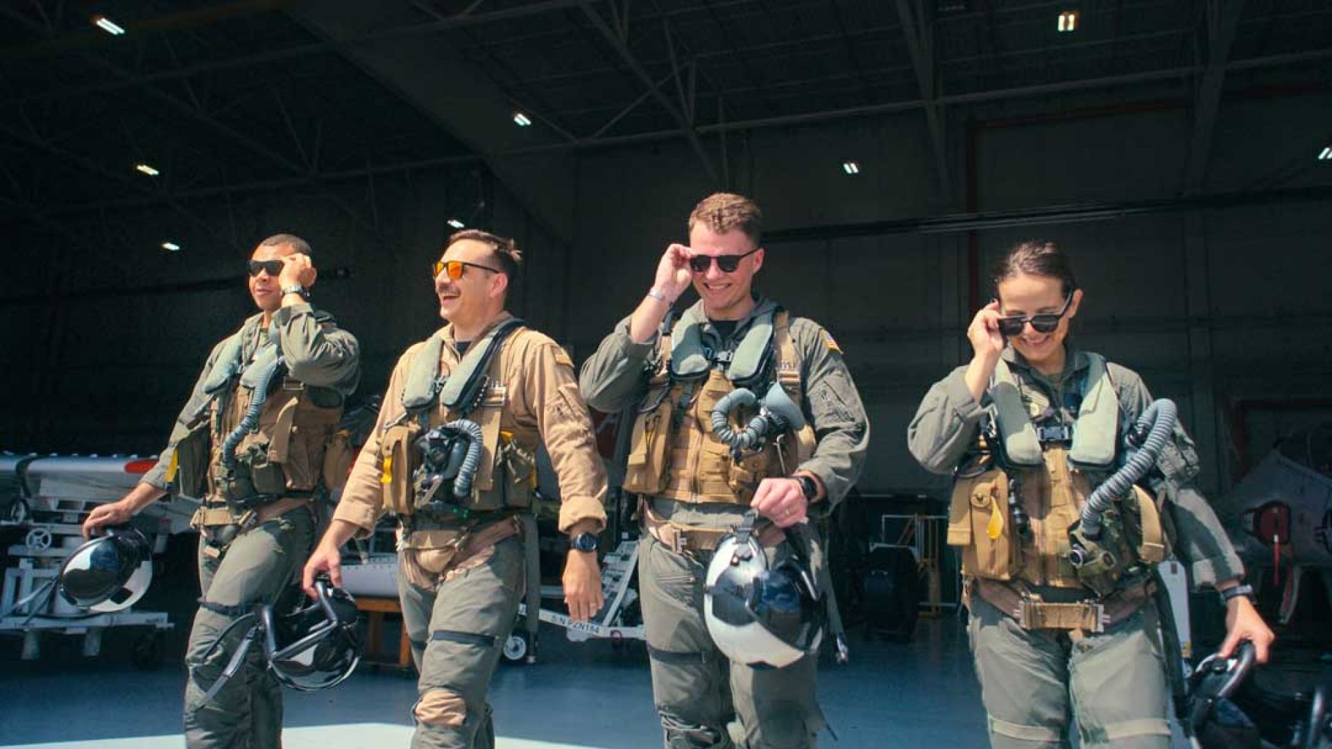Students LT Carissa Meinster and Captain Steph Harris pose behind a T-45. (Credit: National Geographic/Freddie Claire)